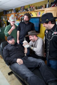 Holy Moly drummer Joe Carpenter gets some ink from frontman Joe Rose.