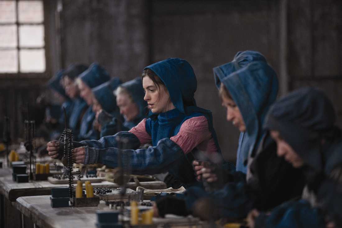 Anne Hathaway (center) and other seamstresses find work in 