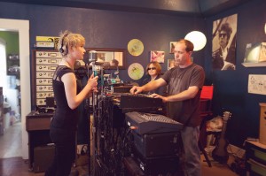 Schuyler Stapleton (left) records vocals with Jennifer and Robby Rux.    