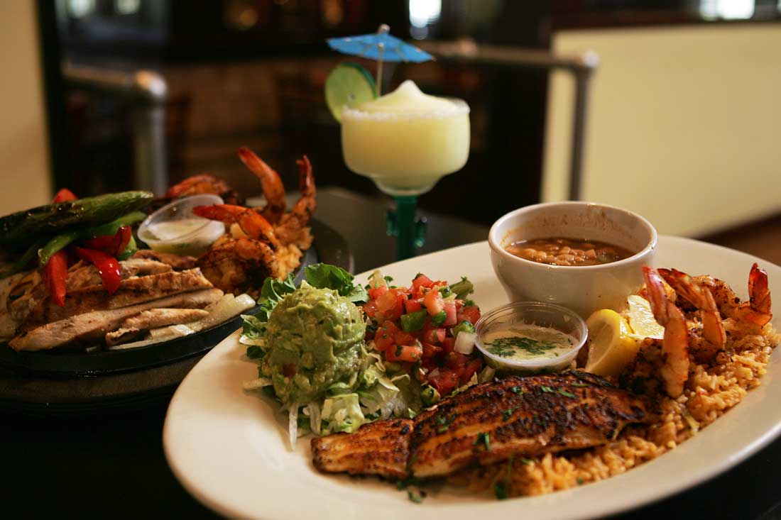 Don Mario’s serves up their Ultimate Fajitas (left) and a platter of catfish and shrimp. Lee Chastain