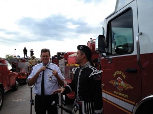 Goodwin (left) finishes putting on his dress uniform for a memorial service in Waco. Next to him is Brent Batla, a Burleson firefighter and one of 300  pipers who played at the service. Courtesy Grace Goodwin