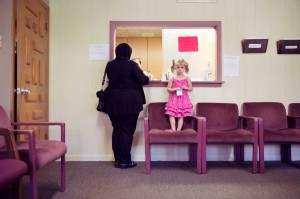 A patient checks out at the MCC clinic with her young daughter. The center helps Muslim families with everything from dental care to referrals for social services.