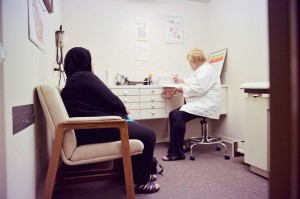 Nurse practitioner Sandra Pinkston talks with a patient at the Al-Shifa clinic.