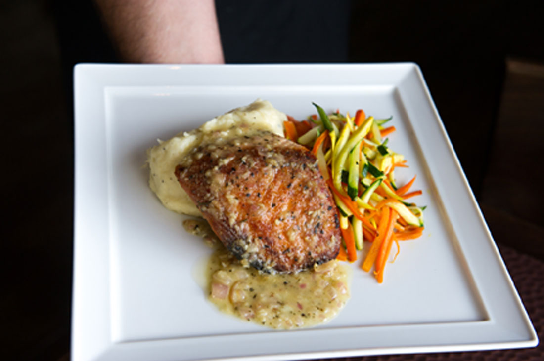 Chef Nelson serves up some salmon at his new joint. Brian Hutson