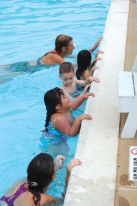 Cannell (third from right) got her swim team involved in water safety education. Left to right: Terry Woods, Elaina Rowe, Coach Chuck Burr, Sarah Mountjoy, Roger Yates, Cannell, Julie Jackson and Michelle Brannan.  Brian Hutson