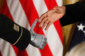 ART_2 President Obama shakes the prosthetic hand of an Army Ranger. AP Photo/Charles Dharapak