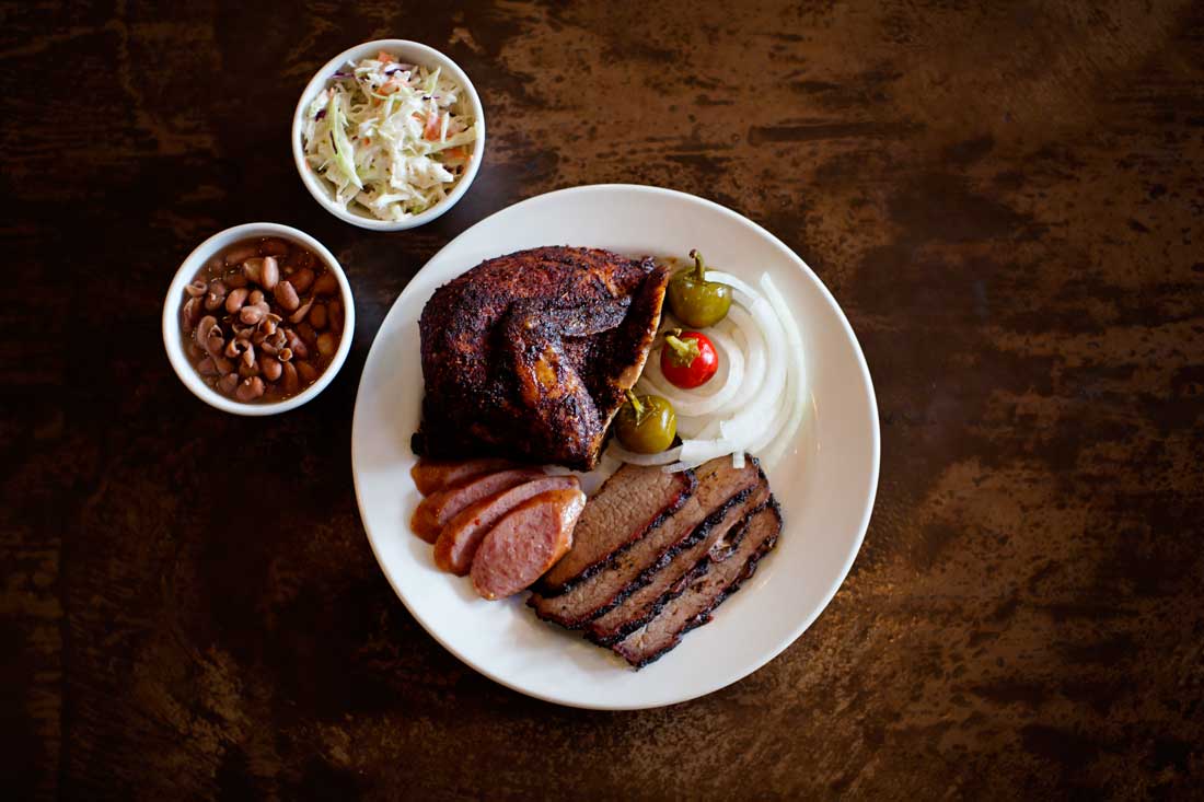 Chicken, sausage, and sliced brisket make a fine plate at the Back Forty Smokehouse. Adrien P. Maroney