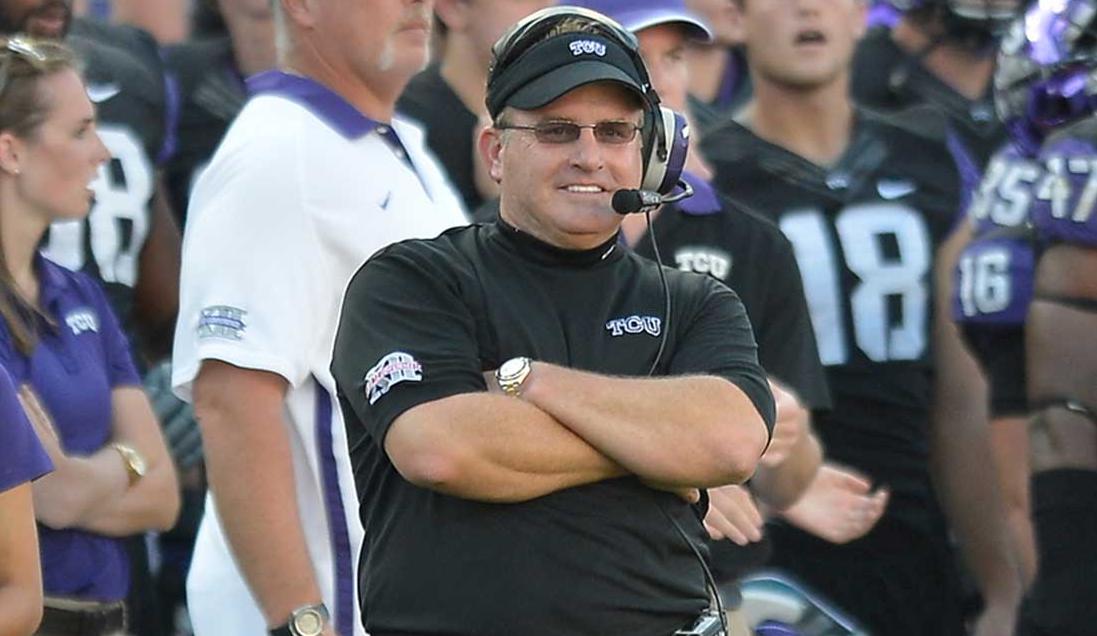 Coach Gary Patterson leads TCU out at Cowboys Stadium, Sat.