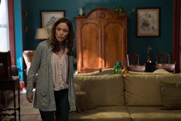 Who's on the sofa behind Rose Byrne in Insidious: Chapter 2?