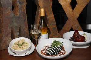 A bottle of vino is the perfect acompaniment  to Max’s (from left to right) mac ’n’ cheese, the chile relleno, and Spanish wine-soaked pears. Lee Chastain