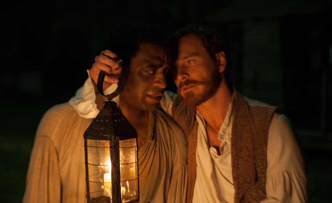 Chiwetel Ejiofor stands up under interrogation by Michael Fassbender in 12 Years a Slave.