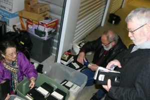 Peggy Bott Kirby and Bob Bourland get down on the floor to organize tapes while Bruce Balentine examines labels. Jeff Prince