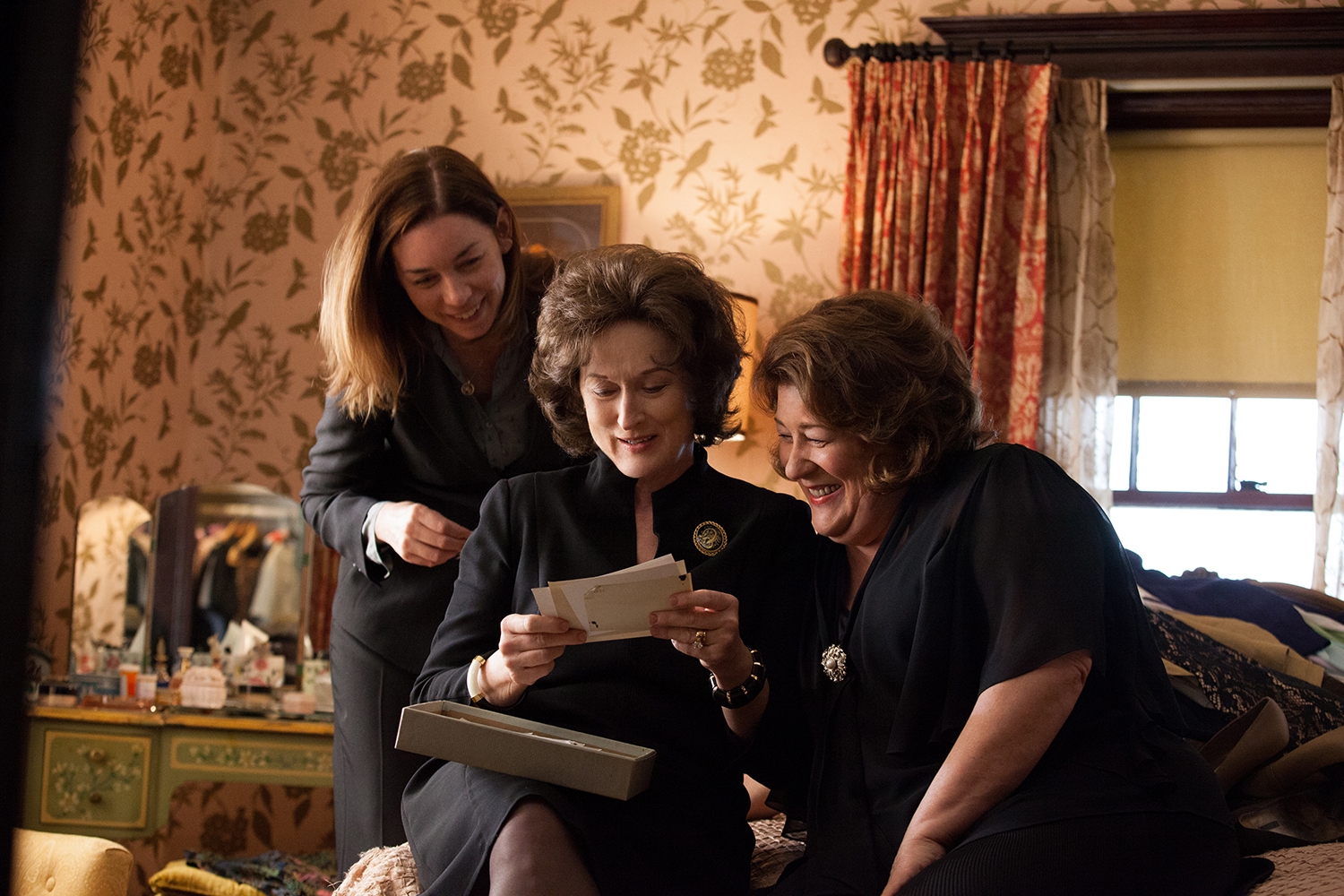 Julianne Nicholson, Meryl Streep, and Margo Martindale consult their family history in August: Osage County.