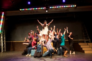 The cast of Into the Woods rehearses a big musical number on the stage of the Rose Marine Theater.