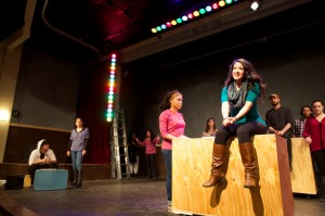 Aigner Mathis (left foreground) and Natalie Coca (center, sitting on box) are part of the cast of Into the Woods.