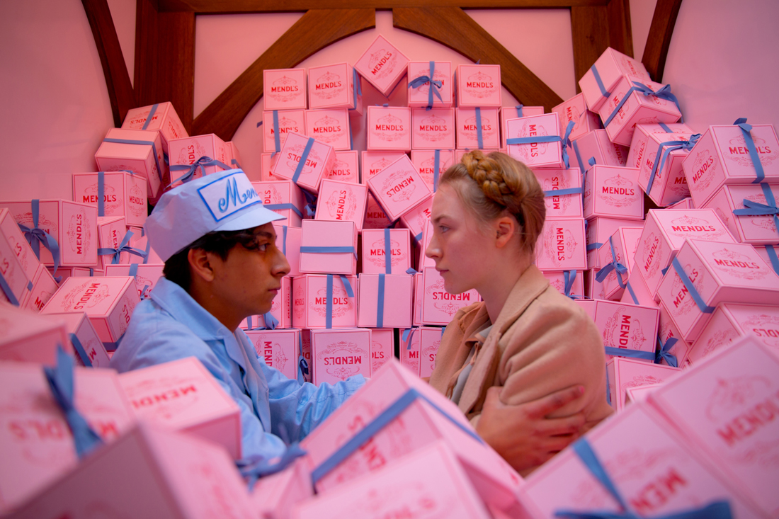 Surrounded by pastry boxes, Tony Revolori and Saoirse Ronan fall in love at The Grand Budapest Hotel.