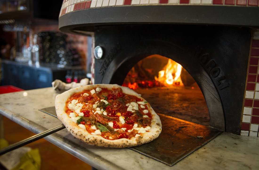 The pies come straight from Cane Rosso’s 900-degree brick oven. Brian Hutson