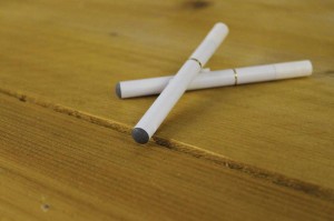 Two electronic cigarettes sit on the wooden counter at North Texas Vapor Shop. The store sells e-cigs and supplies intended for tobacco and not pot. Melissa Wylie