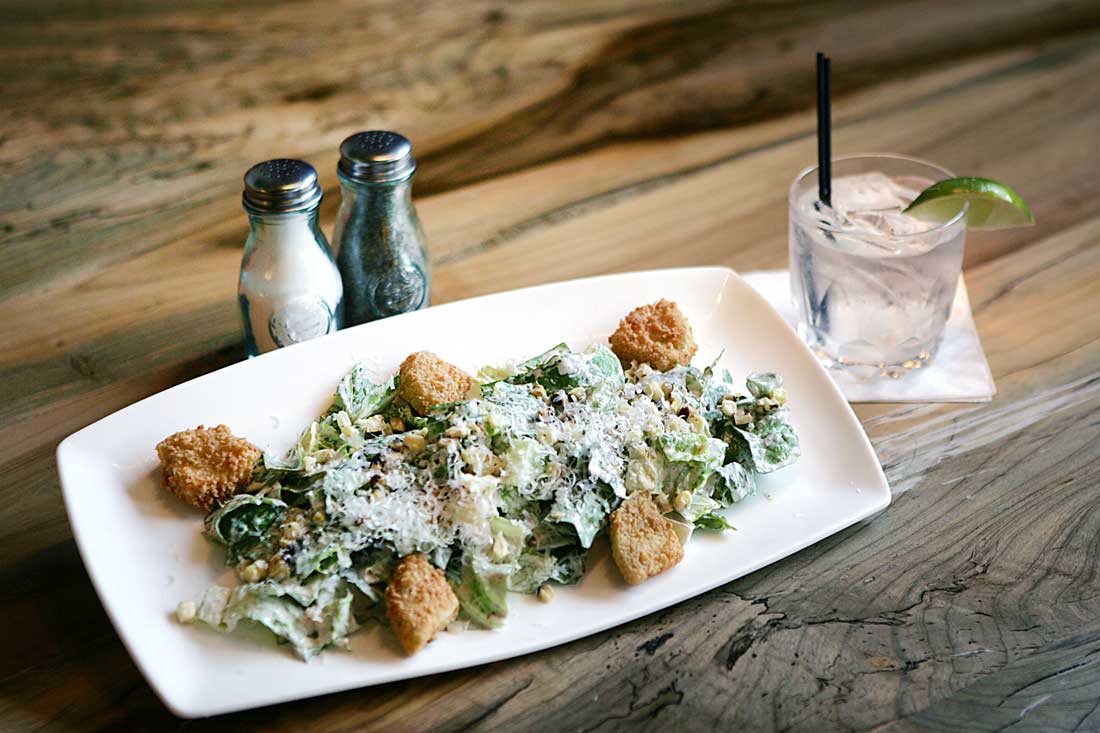 Along with a Bee’s Knees signature cocktail, R Bar & Grill offers a caesar salad with fried green tomatoes. Lee Chastain