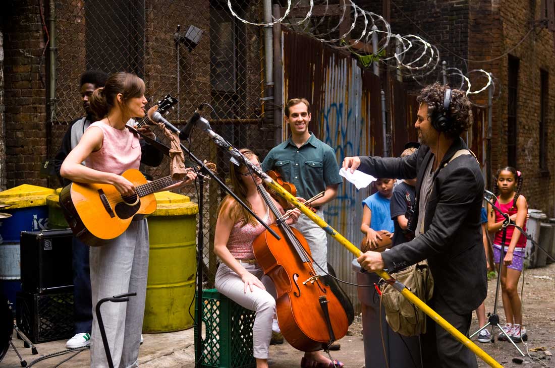 Backed by session musicians and neighborhood kids, Keira Knightley and Mark Ruffalo prepare to record outdoors in Begin Again.