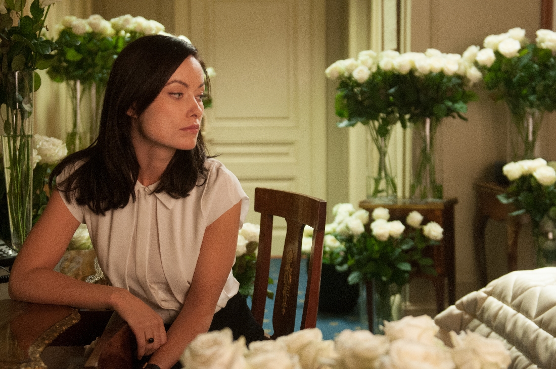 Olivia Wilde finds a lot of white roses in her hotel room in Third Person.