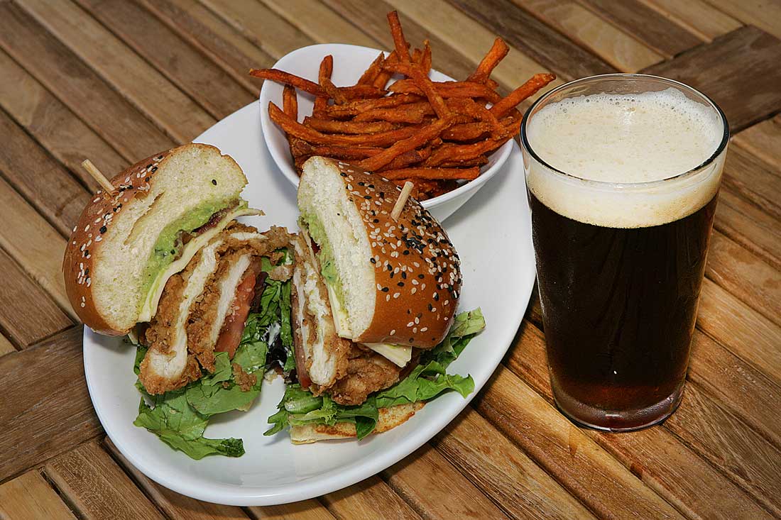 Belly up to East Hampton’s Fried Chicken + Jack, a Southern-fried cutlet with pepper jack cheese, bacon, avocado mash, and greens. Lee Chastain