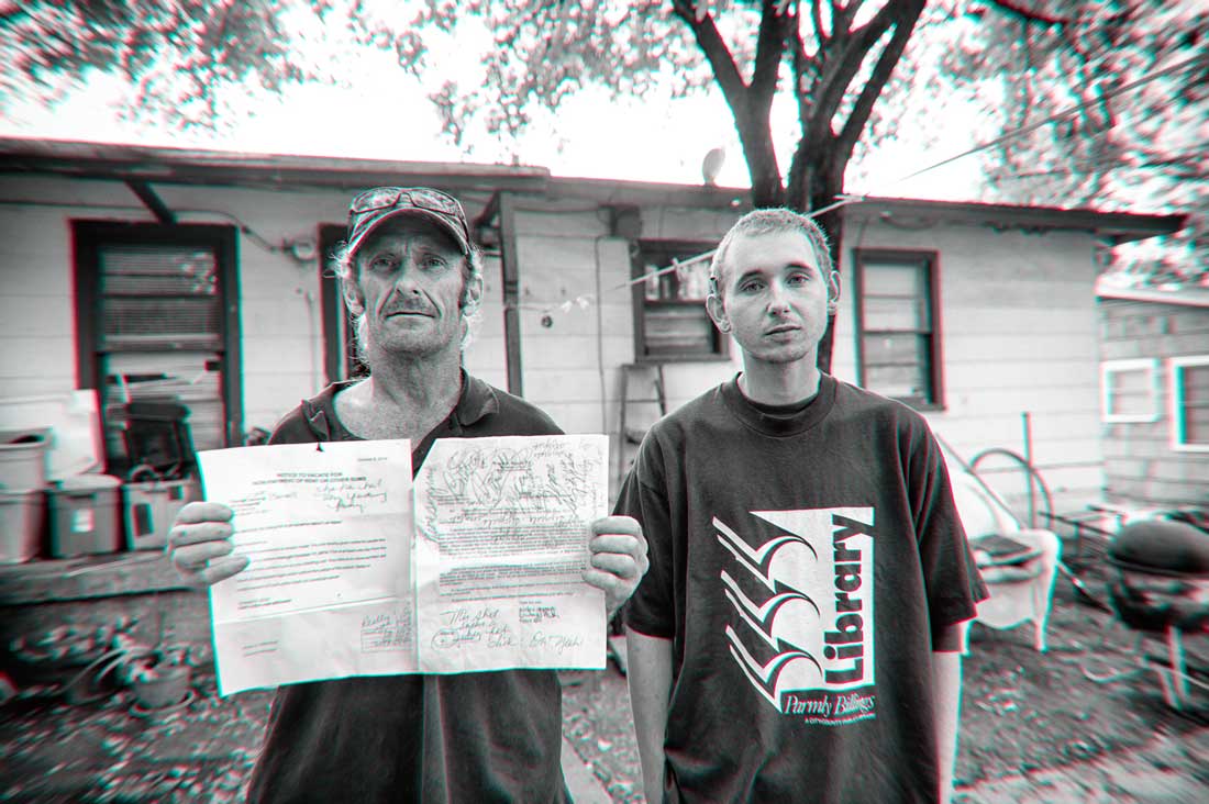 Charles Carroll (left), with R.J. Logan, holds his notice to vacate, to which he has added his own comments. Brian Hutson