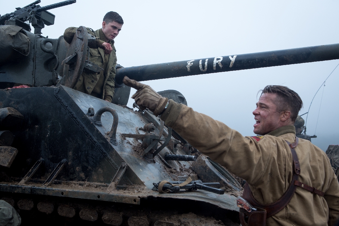 Brad Pitt (foreground) instructs Logan Lerman about operating the tank called Fury.