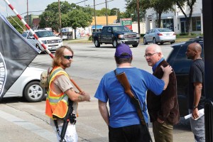 Gun rights activists share their message on an Arlington sidewalk.