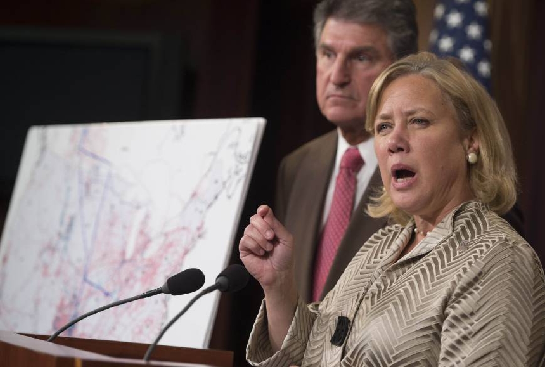 Senator Mary Landrieu, a Democrat from Louisiana, right, speaks as Senator Joe Manchin, a Democrat from West Virginia, looks on during a news conference.