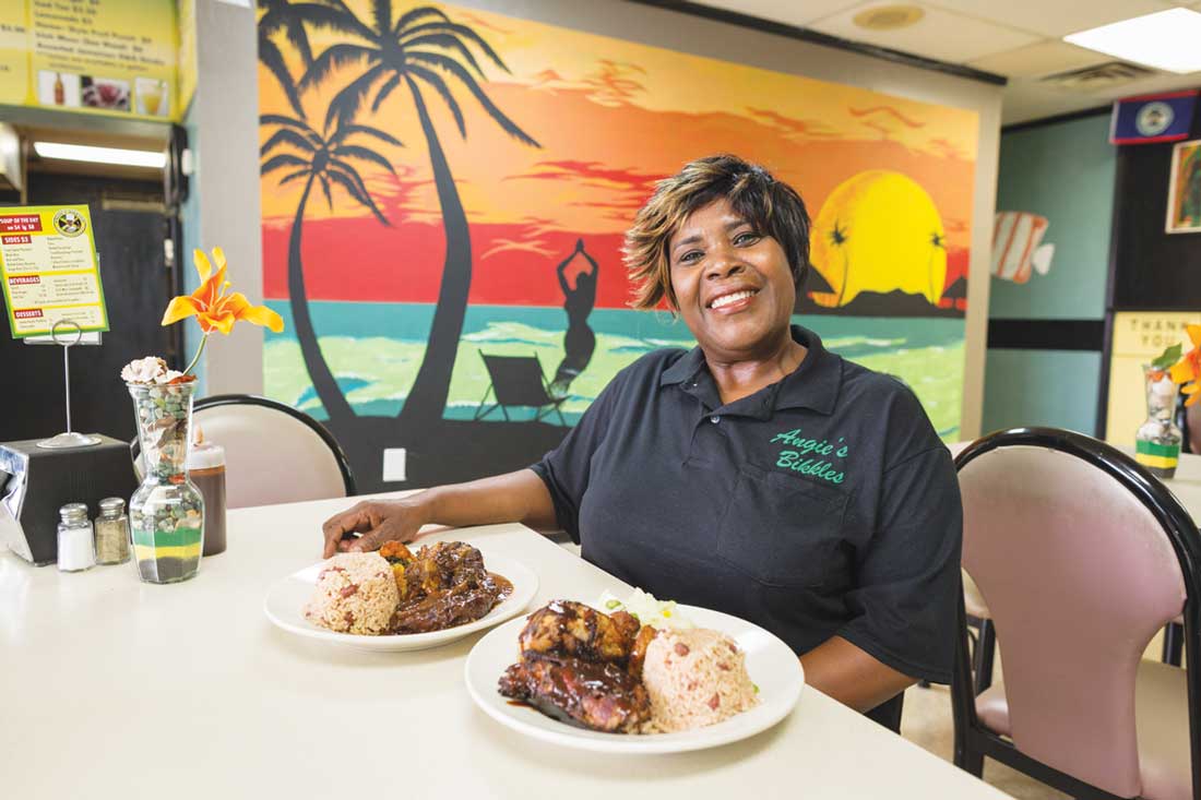 Owner Maureen “Angela” Hucey proudly offers her jerk chicken with steamed cabbage.