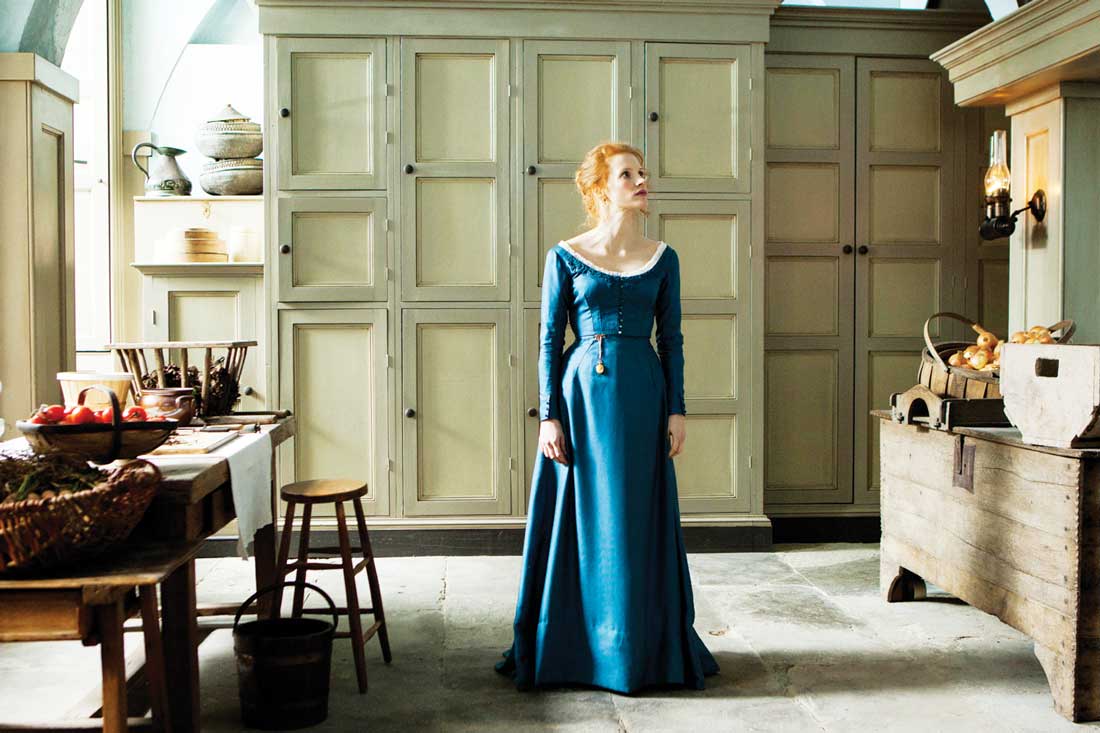 Jessica Chastain wanders the kitchen area in Miss Julie.