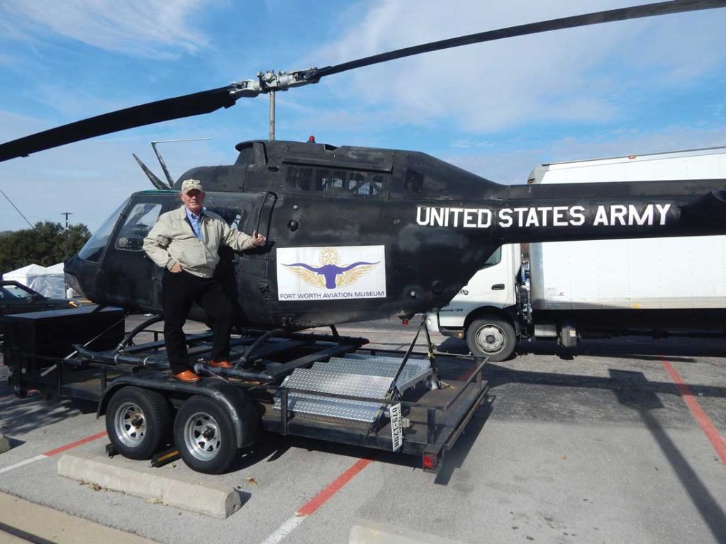 Jim Hodgson, executive director of the Fort Worth Aviation Museum, stands in front of a Kiowa helicopter that saw action in both Vietnam and Desert Storm. Photo by Madeleina Gorman.