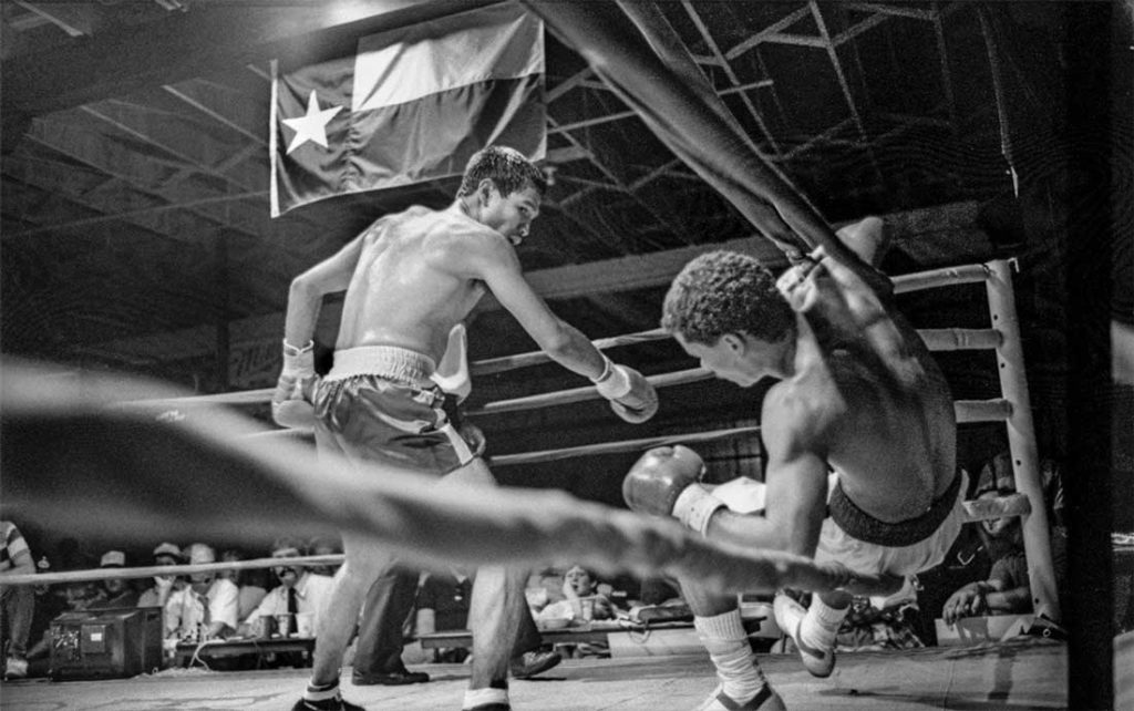 A boxer scores a knockout at Gorman’s Saturday Night Club fights, as photographed by Byrd IV in 1986. Gorman’s was a popular gym near East Cannon Street in Fort Worth. Byrd IV’s photograph is reminiscent of “Dempsey & Firpo,” the famous painting by George Bellows that shows Luis Firpo knocking Jack Dempsey out of the ring in the first round of their fight in New York’s Polo Grounds in 1923.