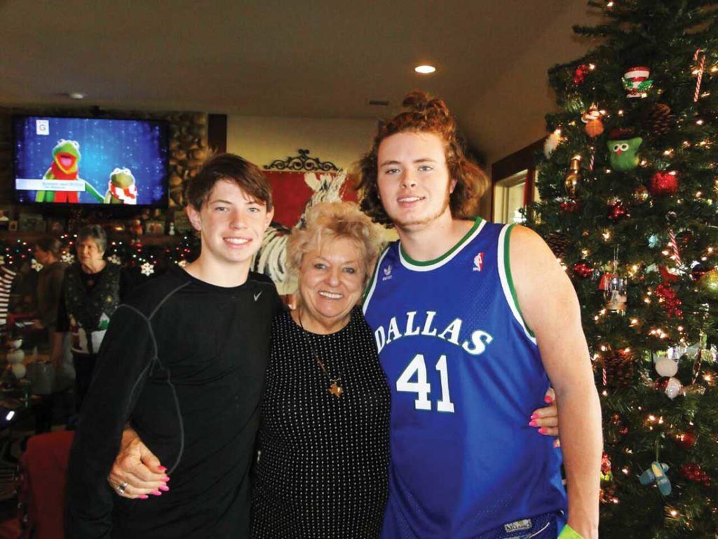 Tanner (left) and Trouper (right) make a grandma sandwich with Arnold. Photo by Jeff Prince.