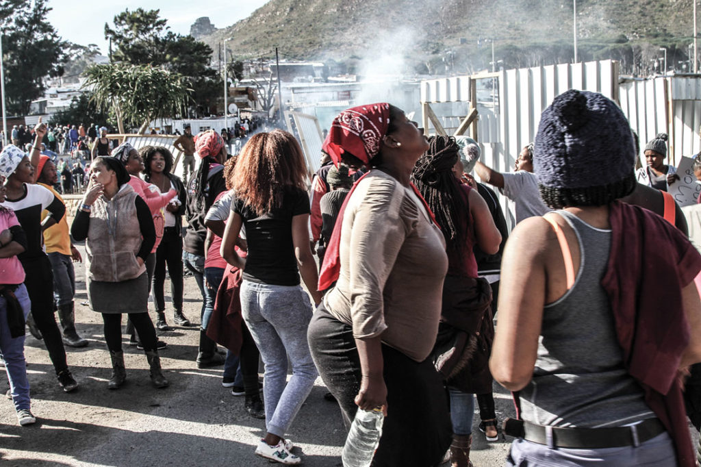 Protesters sing in the streets of Imizamo Yethu, Hout Bay, on July 1, 2017. Photo by Peter Michaels.