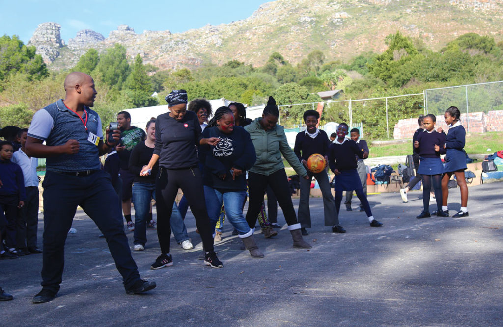 Lelo (far left) dances with students and volunteers during a Youth Day event. Photo by Diamon Garza.