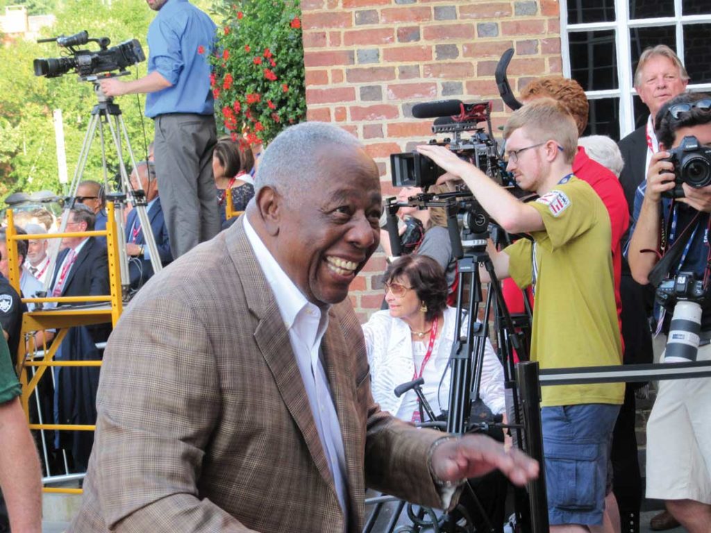 Hank Aaron, who hit 755 home runs, arrives at the Hall of Fame Museum to welcome its newest members.