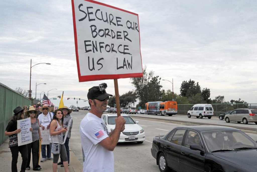 A supporter in Burbank, Calif., has a message for illegal immigrants. Photo by DnHolm.