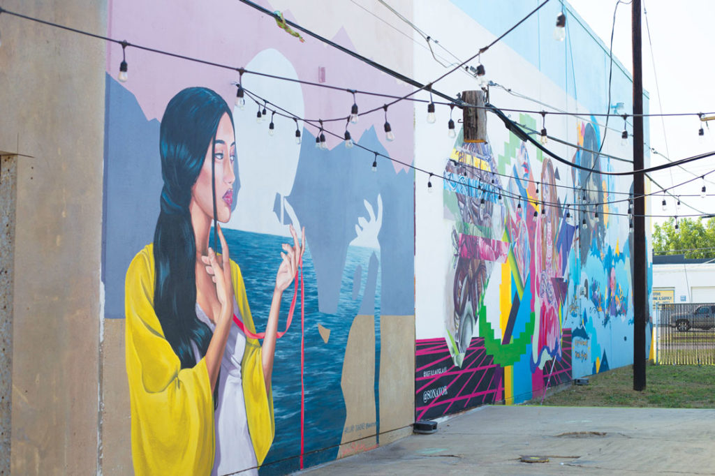 Multiple artists painted a mural of varying shapes, sizes, and themes as part of “Inspiration Alley.” Photo by Cheyenne Hammons. 