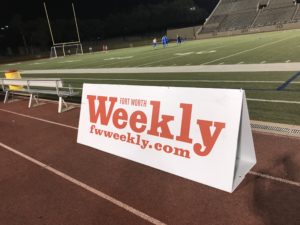 Fort Worth Weekly sign at a Vaqueros game