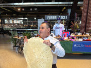 Globe Life Food Chef Chris Vasquez showed off the 26-inch-wide tortilla used for the Boomstick Burrito.